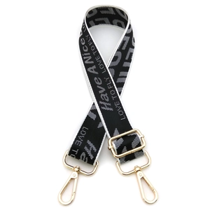 Adjustable wide black canvas shoulder strap with white letter weaving and gold hardware