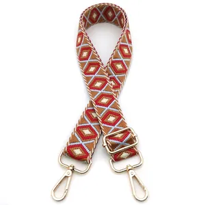 Detail of adjustable geometric diamond pattern bag strap with gold metal lobster clasps