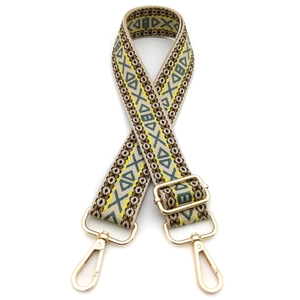 Detail of ethnic jacquard strap with beige geometric patterns and gold metal clasps