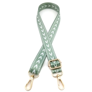 Adjustable light green woven bag strap with white arrow pattern and gold metal hardware