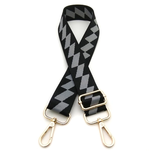 Detail view of adjustable bag strap with black and grey geometric diamond pattern