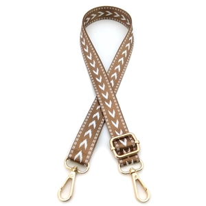 Detail of adjustable woven bag strap with white wave pattern and gold metal lobster clips
