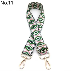 Adjustable bag strap with green and pink diamond pattern and gold metal hooks