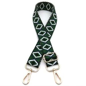 Detail of adjustable woven bag strap Style 12 with green diamond patterns and gold hooks