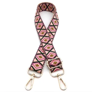 Macro detail of geometric diamond pattern strap with golden metal lobster clasps