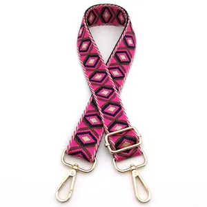 Detail of adjustable magenta bohemian woven bag strap with golden metal swivel hooks