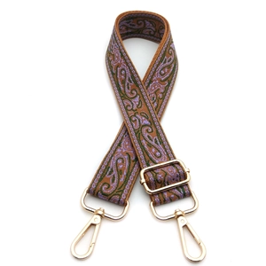 Close-up of ethnic paisley pattern strap with adjustable golden metal lobster clasps