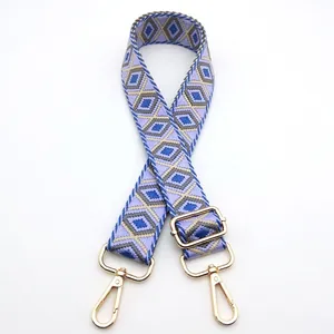 Detailed view of adjustable purple geometric pattern strap with gold metal hooks