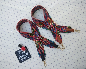 Detail of adjustable wide woven bag straps with colorful geometric jacquard patterns