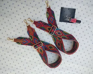 Detail of adjustable colorful woven ethnic style bag straps with gold metal hardware hooks