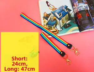 Detailed view of rainbow fabric wristlet straps with golden lobster clasps and ring