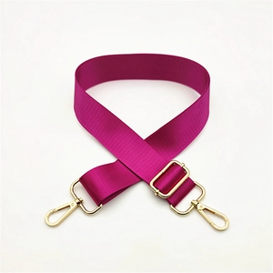 Detail of purple adjustable nylon bag strap with polished gold-tone metal lobster clasps