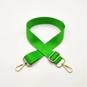 Detail of adjustable bright green nylon strap with gold metal lobster clasps and hardware