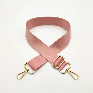 Detail of adjustable nylon bag strap in dusty pink with gold hardware hooks