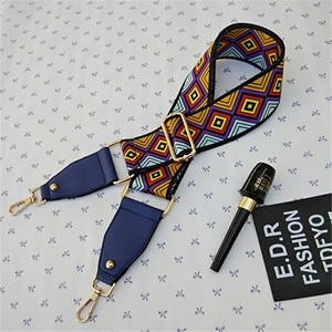 Detail of adjustable colorful geometric woven strap with gold metal hooks and blue leather