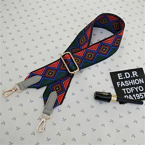 Detail of adjustable colorful geometric diamond patterned wide shoulder strap with gold hooks