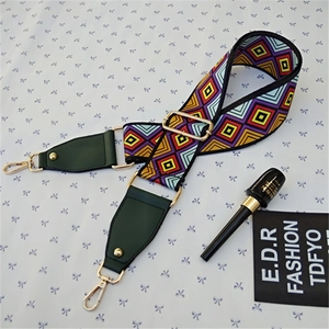 Detail of adjustable geometric ethnic strap with green leather and gold metal clips