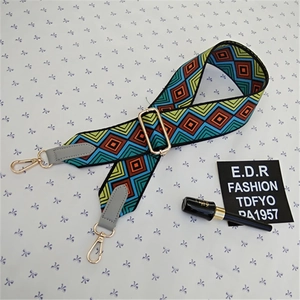 Detail of colorful geometric ethnic pattern wide strap with gold lobster clasps