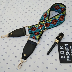 Detail of adjustable geometric strap with bohemian pattern and golden metal hardware
