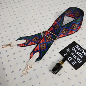 Detail of adjustable wide shoulder strap with colorful geometric weaving and gold lobster claws