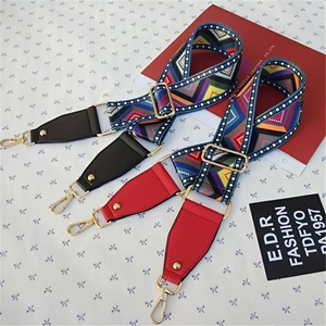 Close-up of adjustable ethnic geometric wide shoulder strap with golden metal lobster clasps
