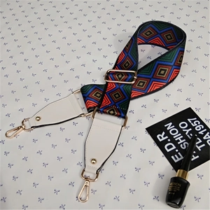Close-up of adjustable colorful wide strap with geometric patterns and gold metal hooks