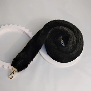 Close-up of soft black faux fur bag strap featuring durable gold-toned metal lobster clasps