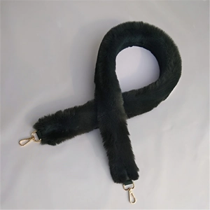 Close-up of fluffy dark green plush shoulder strap with golden metal swivel hooks