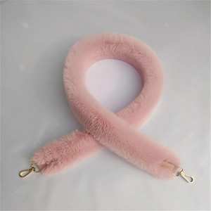 Detail shot of plush pink faux fur bag strap featuring durable gold metal lobster clasps