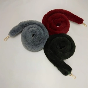 Detailed view of plush faux fur replacement straps in grey, burgundy and black with gold hooks