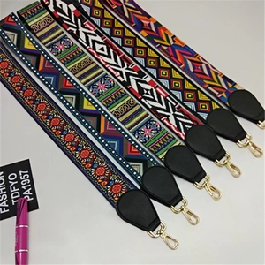 Detail of colorful ethnic wide straps with golden metal hooks and bohemian patterns