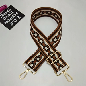 Detail of adjustable wide bag strap with geometric chain pattern and gold metal hooks