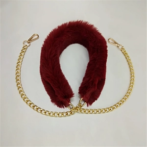 Detail view of plush wine red faux fur strap with gold metal chain and lobster clasps