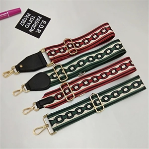 Adjustable woven shoulder straps with vintage patterns and gold metal swivel hooks