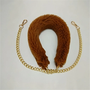 Detail view of brown faux fur bag strap with gold metal chain and lobster clasps