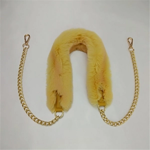 Detail showing plush yellow faux fur shoulder pad with gold metal chain and lobster clasps