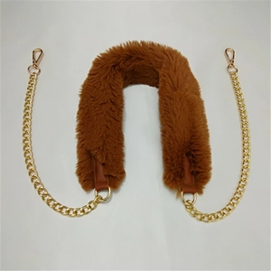 Detail view of caramel brown faux fur shoulder strap with elegant gold metal chains