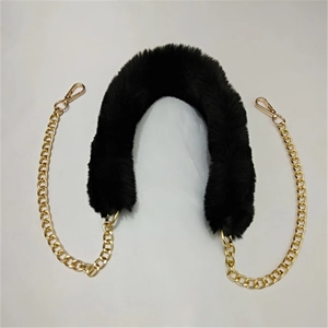 Detail of black faux fur bag strap with golden metal ring chains and lobster clasps