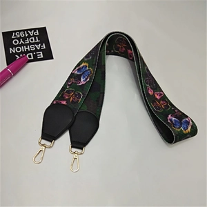 Close-up of colorful butterfly print nylon bag strap with gold metal lobster clasps