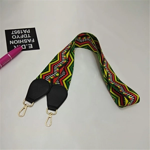Close-up of ethnic style rainbow geometric wave pattern strap with golden lobster clasp
