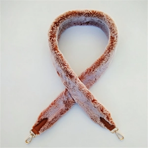 Detail of pink faux rabbit fur shoulder strap with leather ends and golden metal hooks