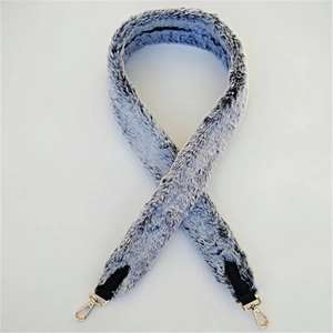 Detail of soft faux rabbit fur bag strap in grey blue with gold metal lobster clasps
