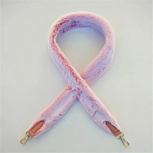 Close-up of pink faux rabbit fur bag strap with golden lobster clasps and leather trim