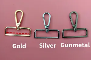 Close-up of swivel lobster clasps in gold, silver, and gunmetal finishes for bag straps
