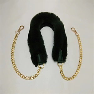Detailed view of dark green faux fur bag strap with polished gold metal chains and clasps