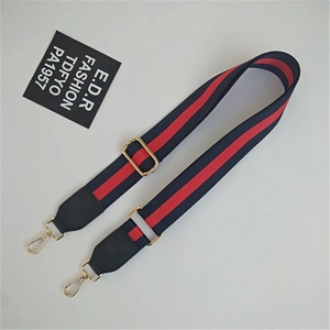 Detail of adjustable ethnic style striped strap with golden metal lobster clasps