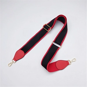Detail view of adjustable ethnic style bag strap with red nylon webbing and gold lobster clasp