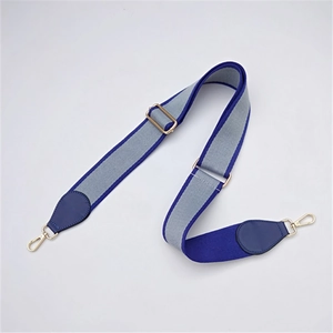 Adjustable bag strap with grey and blue fabric, gold metal clasps and leather ends