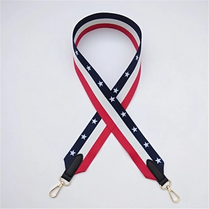 Detail of American flag pattern shoulder strap with golden metal lobster clasps