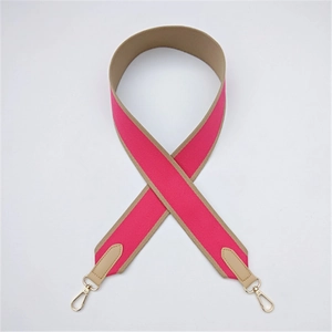 Macro detail of rose red wide canvas strap with khaki leather ends and gold metal hooks